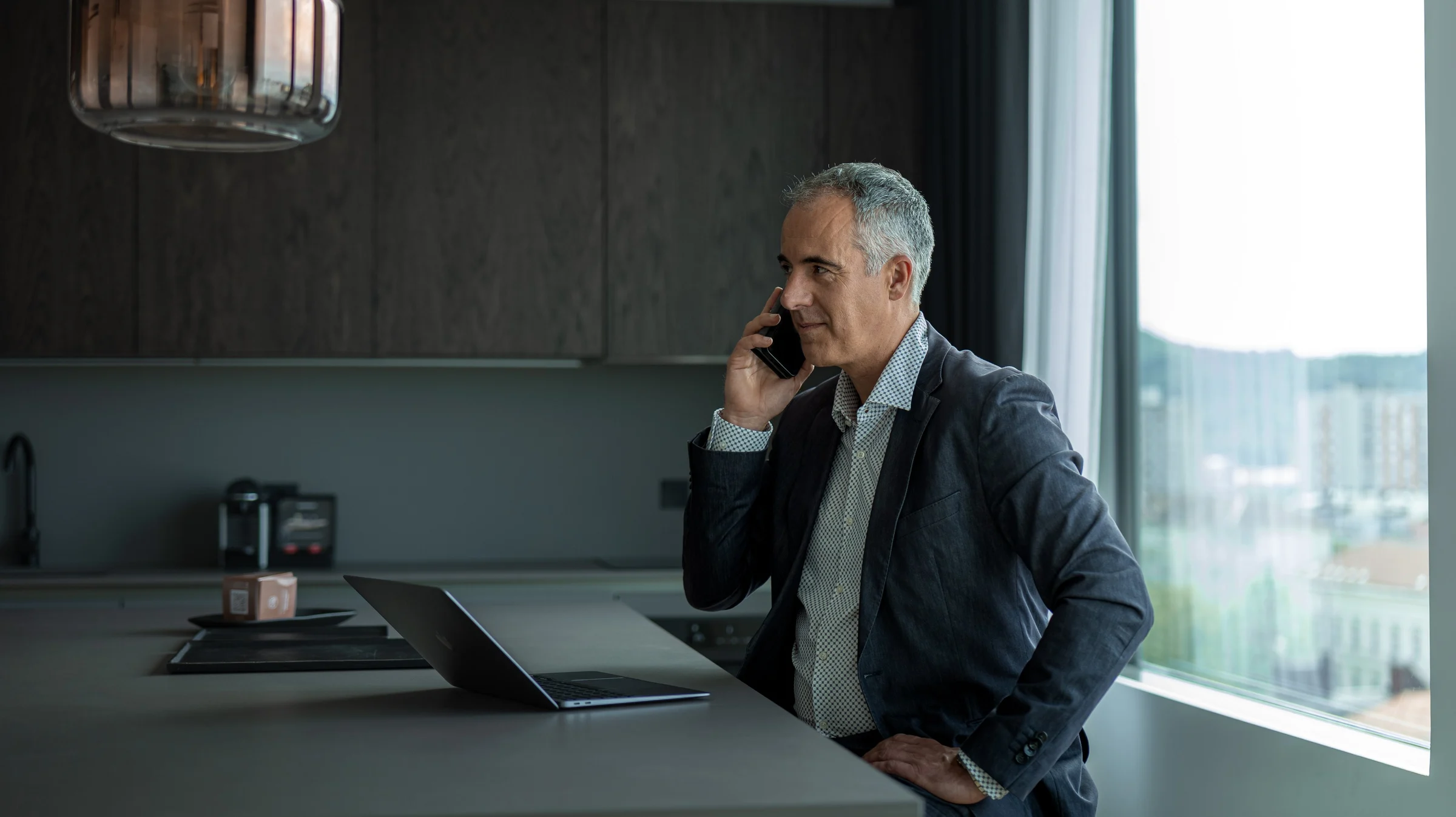 a man in a suit and tie is talking on the phone