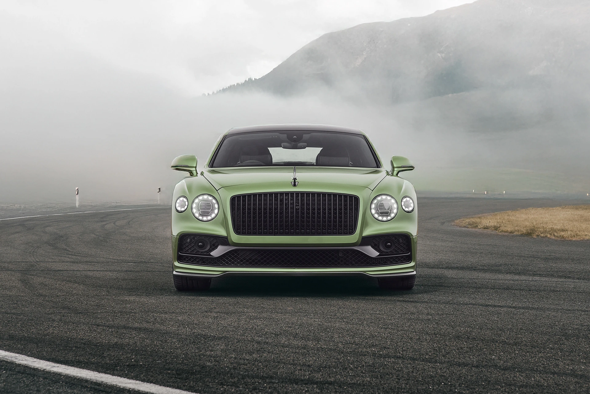 A green Bentley Flying Spur in the Swiss mountains