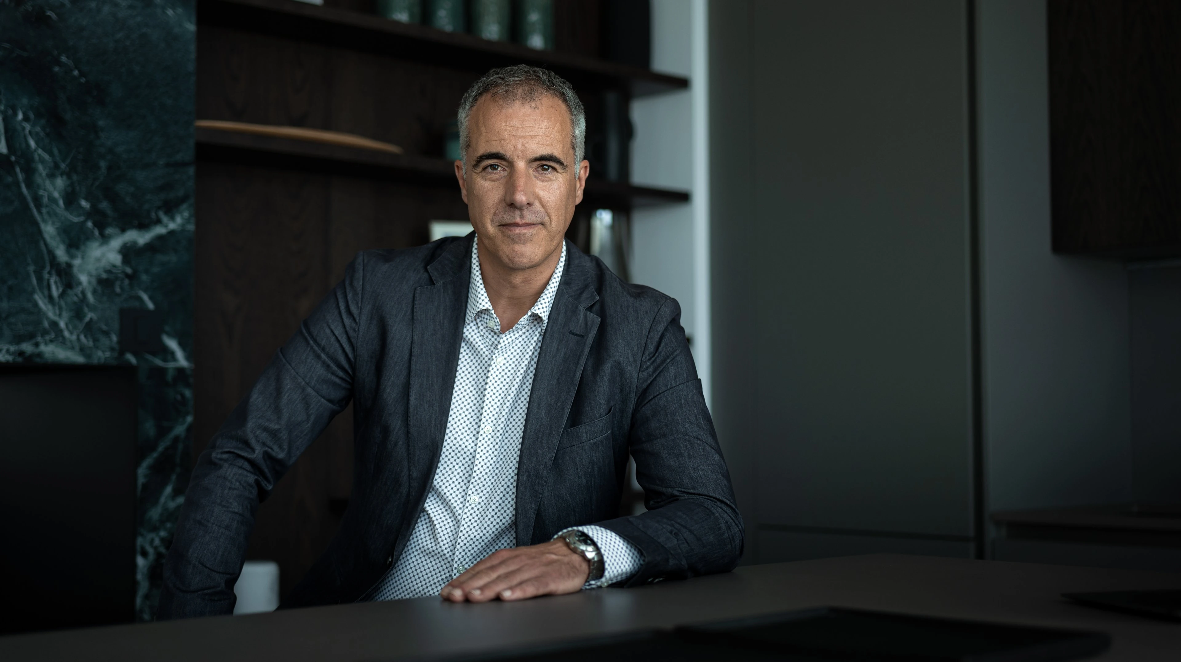 Portrait of a businessman in a suit at his desk